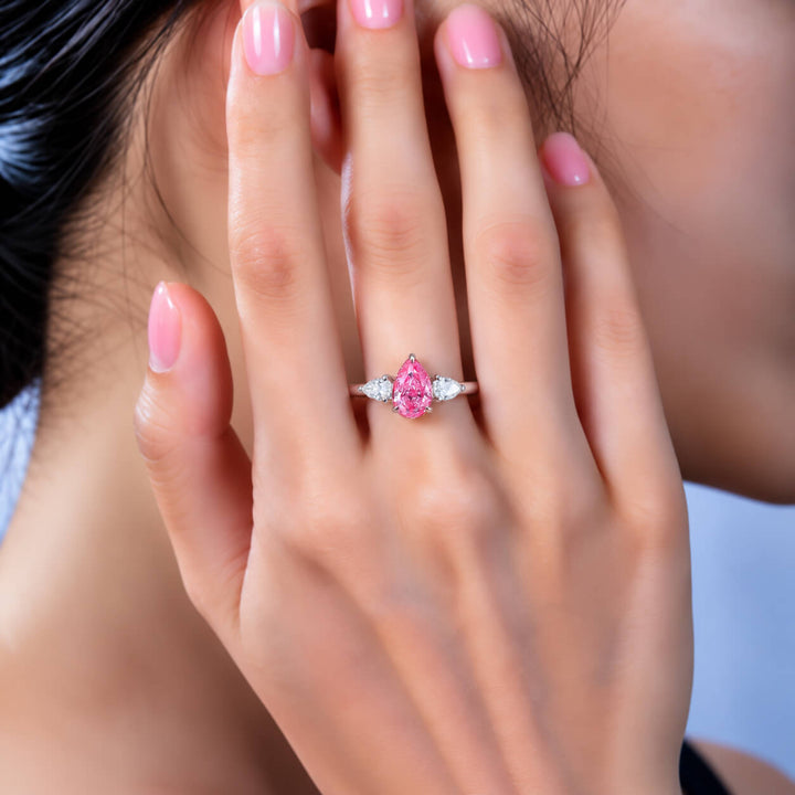 Pear cut lab grown pink diamond three stones engagement ring